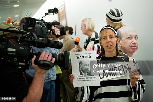 Protester wearing a jail suit calls for Lloyd C. Blankfein, chairman and chief executive officer of Goldman Sachs Group Inc., to be jailed outside a...