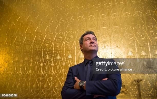 June 2018, Germany, Munich: Markus Soeder , Premier of Bavaria, standing during a tour through the Queen's throne room after the state reception for...