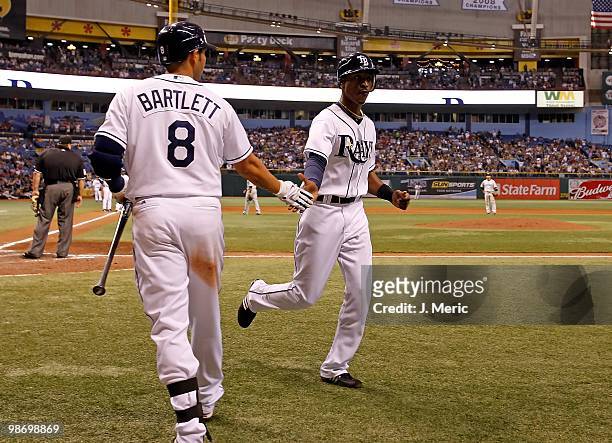 Infielder Jason Bartlett congratulates outfielder B.J. Upton of the Tampa Bay Rays after scoring a run against the Toronto Blue Jays during the game...