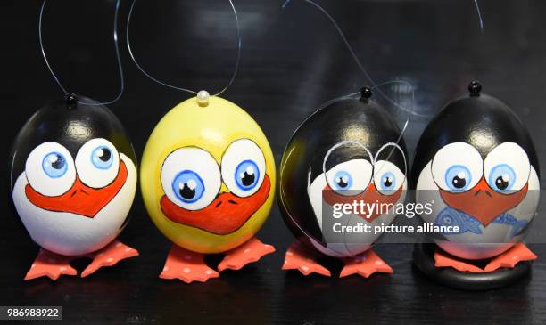 Dpatop - Easter eggs decorated as penguines and a duck created by Easter egg painter Susanne Liebscher are on display in the workshop of hobby Easter...