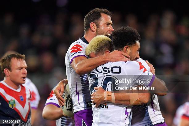 Nelson Asofa-Solomona of the Storm celebrates with his team mates after scoring a try during the round 16 NRL match between the Sydney Roosters and...