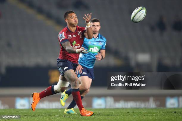 Duncan Paia'aua of the Reds passes during the round 17 Super Rugby match between the Blues and the Reds at Eden Park on June 29, 2018 in Auckland,...