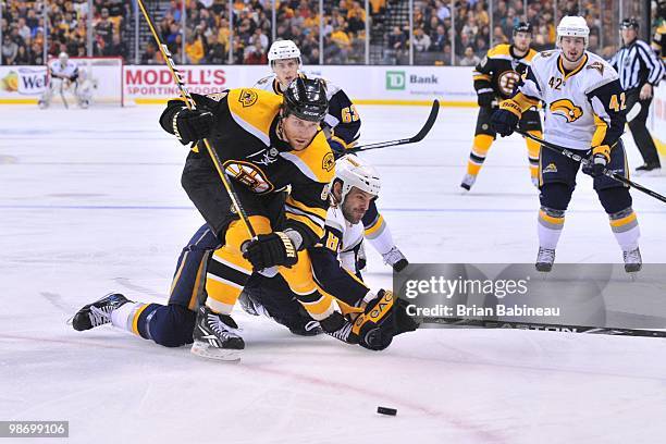 Dennis Wideman of the Boston Bruins skates after the puck against Paul Gaustad of the Buffalo Sabres in Game Six of the Eastern Conference...