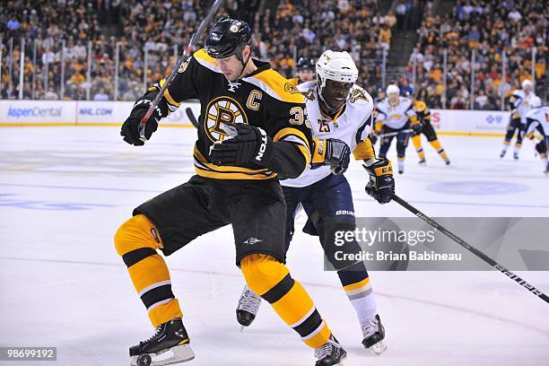 Zdeno Chara of the Boston Bruins watches the loose puck against Michael Grier of the Buffalo Sabres in Game Six of the Eastern Conference...