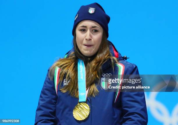 Sofia Goggia from Italy standing on the podium with her gold medal during the award ceremony of the women's alpine skiing event of the 2018 Winter...