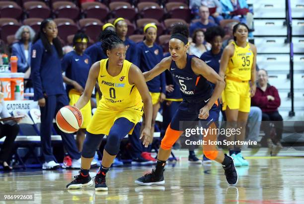 Indiana Fever guard Kelsey Mitchell and Connecticut Sun guard Jasmine Thomas in action during a WNBA game between Indiana Fever and Connecticut Sun...