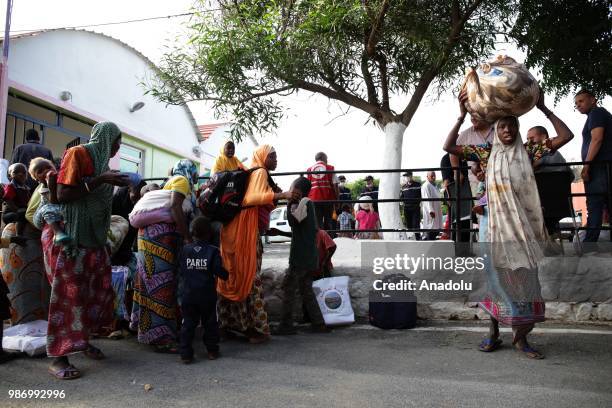 African migrants who were arrested in Algeria while illegally attempting to get to Europe, leave the refugee camp located in the Zeralda region,...