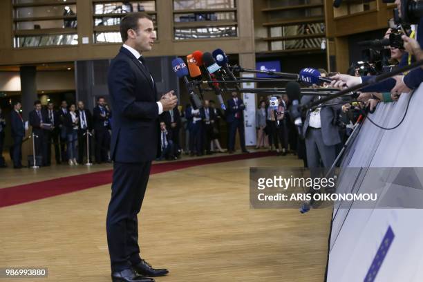 France's President Emmanuel Macron speaks to journalists during the last day of the European Union leaders' summit, without Britain, to discuss...