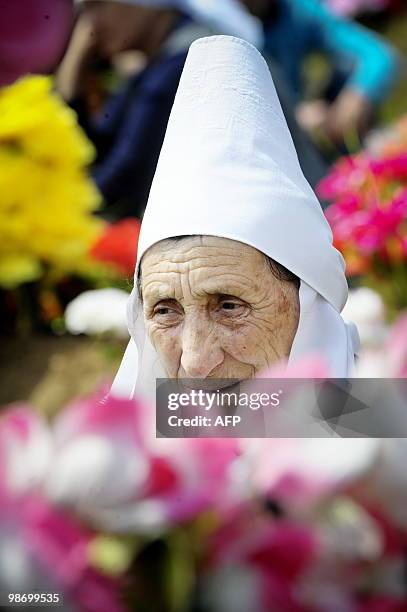 Kosovo Albanian woman pays tribute during a ceremony to mark the Day of Missing Persons at the cemetery in the village of Meje on April 27, 2010....