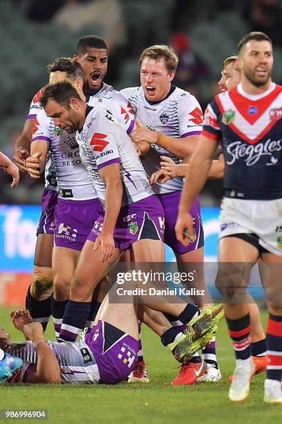 Melbourne Storm players celebrate during the round 16 NRL match between the Sydney Roosters and the Melbourne Storm at Adelaide Oval on June 29, 2018...