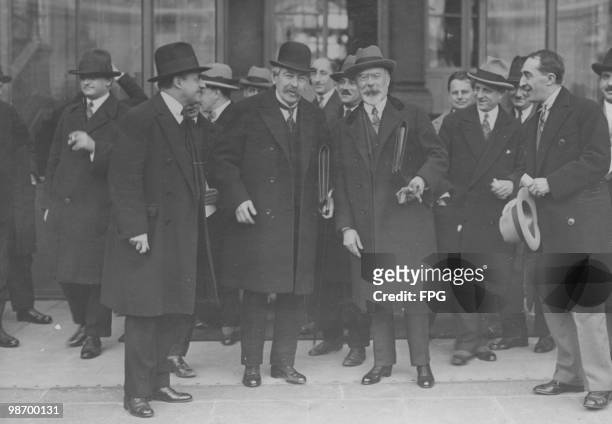 French Foreign Minister Aristide Briand with Louis Barthou , the French Minister of Justice, surrounded by French and American journalists outside...