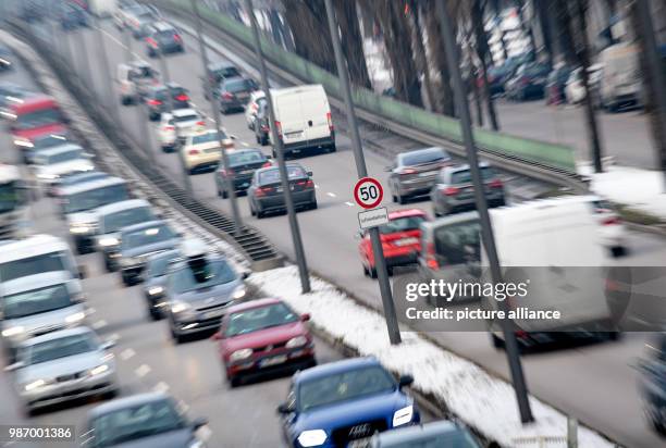 February 2018, Germany, Munich: Dense traffic along the Mittlere Ring. A sign indicates a speed limit of 50 km/h for the air pollution control. The...