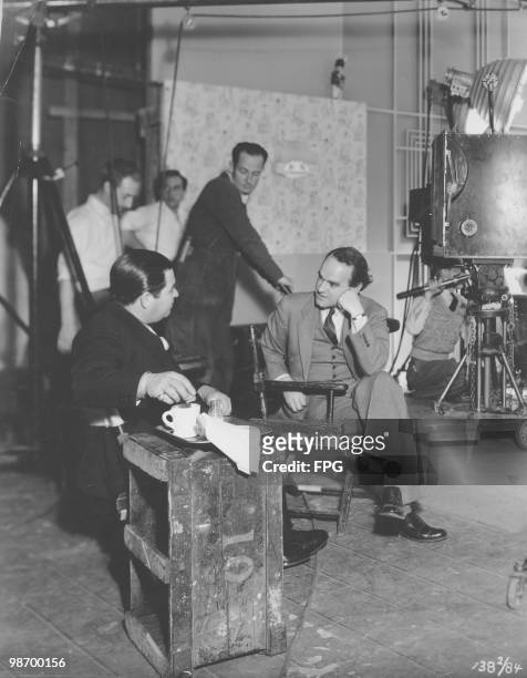 Lyricist Lew Brown and director Hamilton MacFadden on the set of 'Fox Follies', later released as 'Stand Up and Cheer!', 1934.