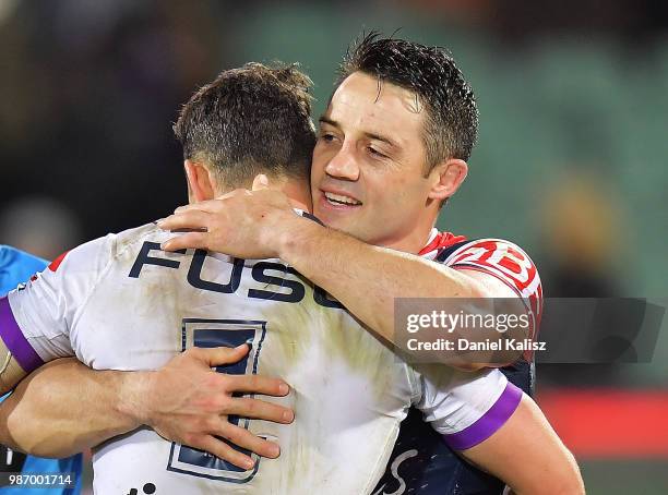 Billy Slater of the Storm and Cooper Cronk of the Roosters embrace after the round 16 NRL match between the Sydney Roosters and the Melbourne Storm...