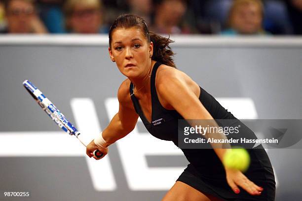 Agnieszka Radwanska of Poland plays a fore hand during her first round match against Ana Ivanovic of Serbia at day two of the WTA Porsche Tennis...