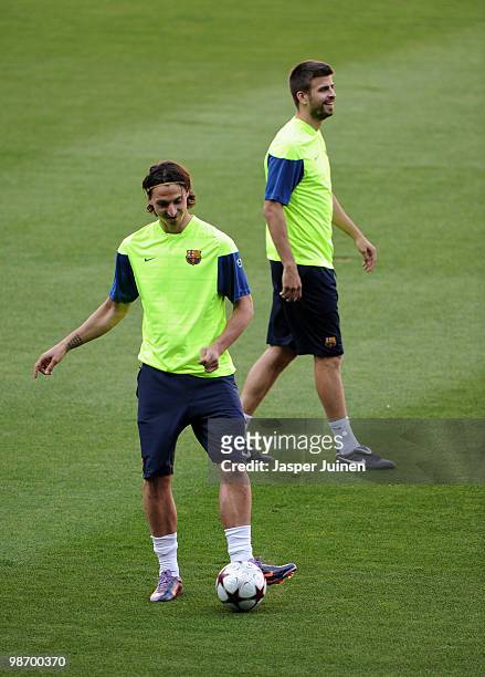 Zlatan Ibrahimovic of FC Barcelona flanked by his teammate Gerard Pique during a training session ahead of their UEFA Champions League semi final...