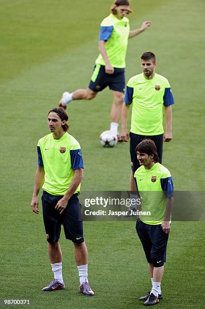 Lionel Messi of FC Barcelona strands flanked by his teammates Zlatan Ibrahimovic and Gerard Pique during a training session ahead of their UEFA...