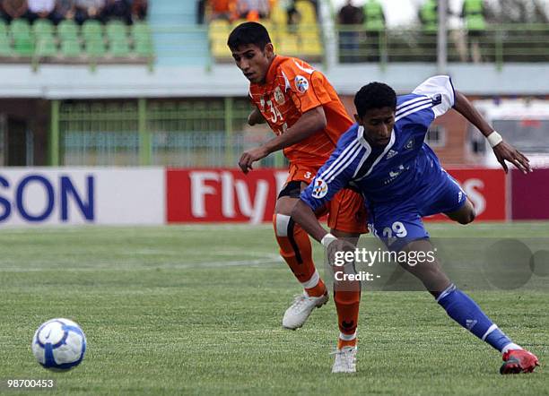 Milad Fakhreddin of Iran's Mes Kerman club vies with Mohammad al-Anbar of Saudi Al-Hilal club during their AFC Champions League football match in the...