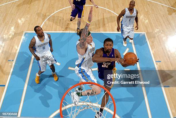 Ron Artest of the Los Angeles Lakers jumps to the basket for a layup against Chris Andersen of the Denver Nuggets during the game at Pepsi Center on...