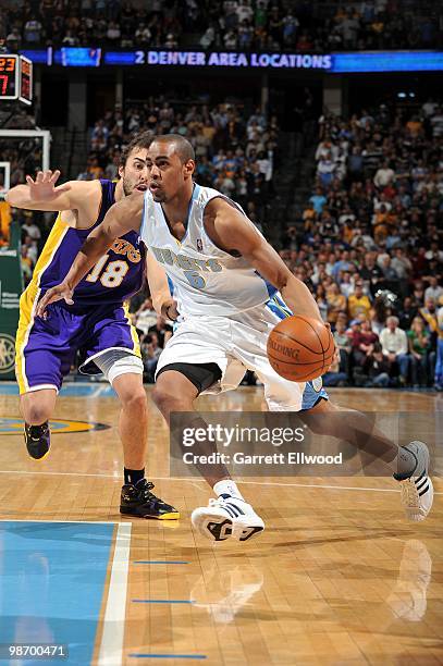 Arron Afflalo of the Denver Nuggets dribble drives to the basket past Sasha Vujacic of the Los Angeles Lakers during the game at Pepsi Center on...