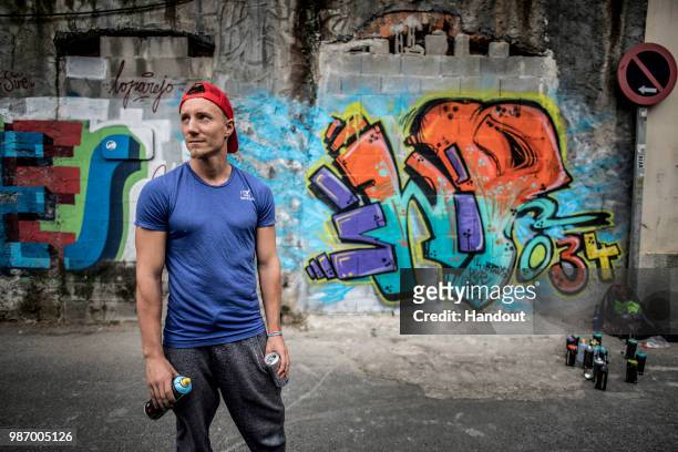 In this handout image provided by Red Bull, Kris Kolanus of Poland poses for a portrait while making graffiti art prior to second stop at the Red...