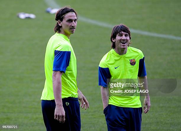 Barcelona's Swedish forward Zlatan Ibrahimovic and Argentinian forward Lionel Messi takespart in a training session on the eve of his team's UEFA...
