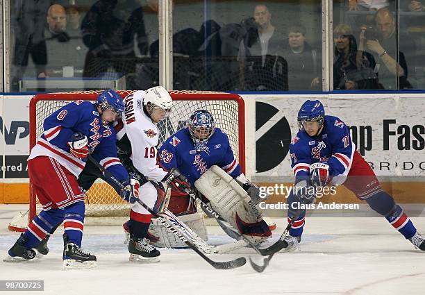 Zack Kassian of the Windsor Spitfires tries to get a shot away at Mike Morrison of the Kitchener Rangers in Game 6 of the Western Conference Final on...