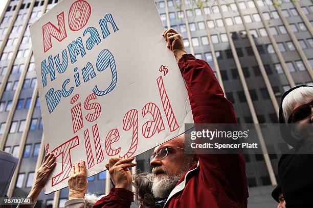 Couple holds up a sign in support of illegal immigrants on April 27, 2010 outside of Federal Plaza in New York City. Following the state of Arizona's...