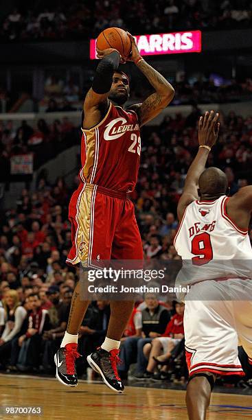 LeBron James of the Cleveland Cavaliers puts up a shot over Luol Deng of the Chicago Bulls in Game Four of the Eastern Conference Quarterfinals...