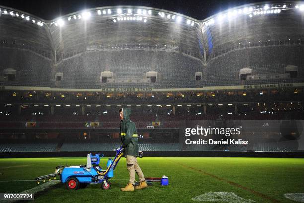 Adelaide Oval ground staff help prepare the ground for tomorrow's AFL game after the round 16 NRL match between the Sydney Roosters and the Melbourne...
