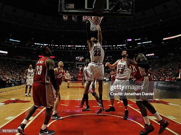 Taj Gibson of the Chicago Bulls dunks the ball over teammates Luol Deng and Brad Miller as well as LeBron James, Anthony Parker and J.J. Hickson of...