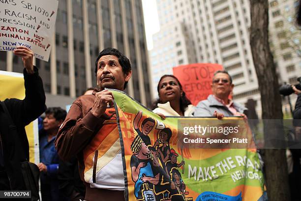 Immigrants, activists and supporters of illegal immigrants rally against a new Arizona law on April 27, 2010 outside of Federal Plaza in New York...