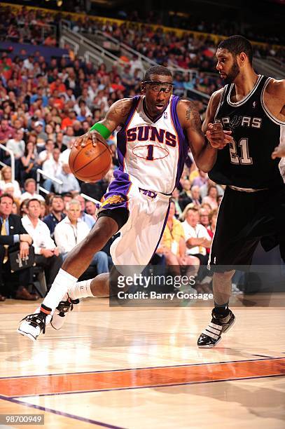 Amare Stoudemire of the Phoenix Suns dribble drives baseline against Tim Duncan of the San Antonio Spurs during the game at U.S. Airways Center on...