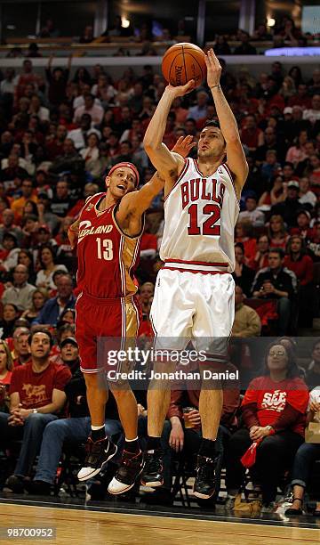 Kirk Hinrich of the Chicago Bulls puts up a shot over Delonte West of the Cleveland Cavaliers in Game Four of the Eastern Conference Quarterfinals...