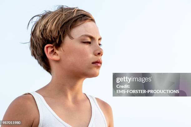 portrait of a cute, bored and thoughtful preadolescent blonde boy. - ems forster productions 個照片及圖片檔