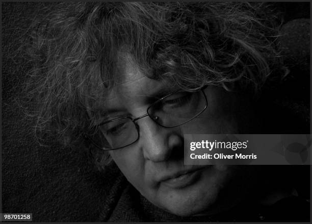 Close-up portrait of Pulitzer Prize-winning Irish poet and educator Paul Muldoon, as he poses with his guitar, with which he performs in the rock...