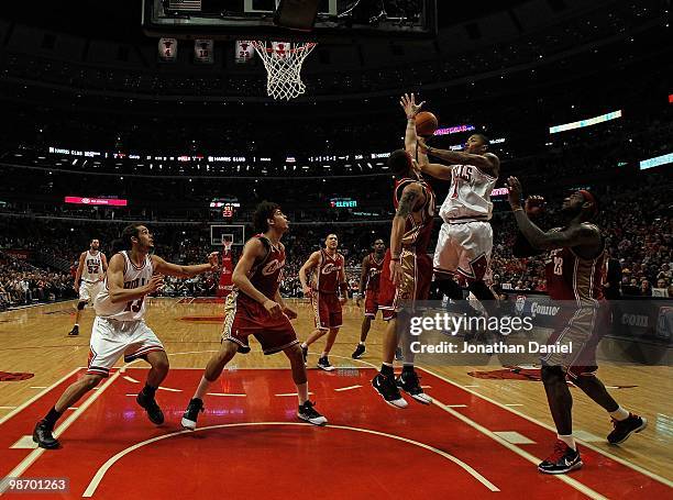 Derrick Rose of the Chicago Bulls drives to the basket over Delonte West and LeBron James of the Cleveland Cavaliers as Anderson Varejao and Joakim...