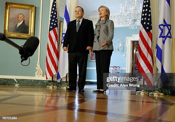 Secretary of State Hillary Clinton speaks to the media as Israeli Defense Minister Ehud Barak listens after a meeting at the State Department April...