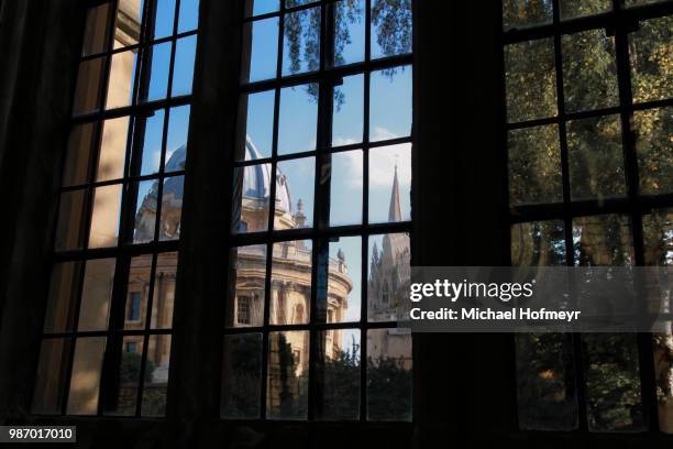 radcliffe camera seen through the divinity school window - radcliffe camera stock pictures, royalty-free photos & images