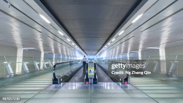 symmetry - moving walkway airport stock pictures, royalty-free photos & images