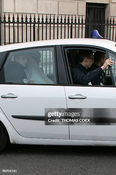 Panama's former dictator Manuel Noriega , hidden under a white fabric, leaves in a car the Paris' court house on April 27, 2010. Manuel Noriega,...