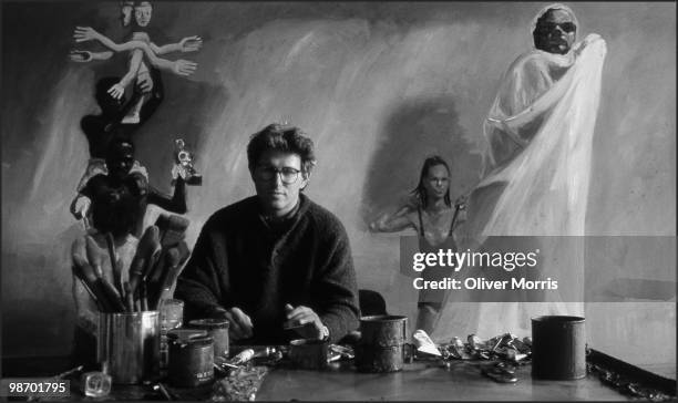 Portrait of American artist Eric Fischl as he poses in front of his painting 'A Brief History of North Africa' in his studio on Canal Street, New...