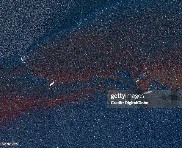 In this satellite image, clean up vessels are seen on the oil slick produced Transocean Deepwater Horizon drilling rig explosion April 26, 2010 in...