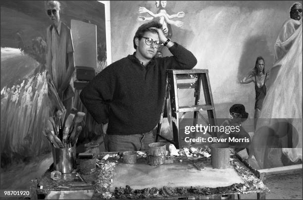 Portrait of American artist Eric Fischl as he poses in front of his painting 'A Brief History of North Africa' in his studio on Canal Street, New...