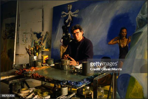 Portrait of American artist Eric Fischl as he poses in front of his painting 'A Brief History of North Africa' in his studio on Canal Street, New...