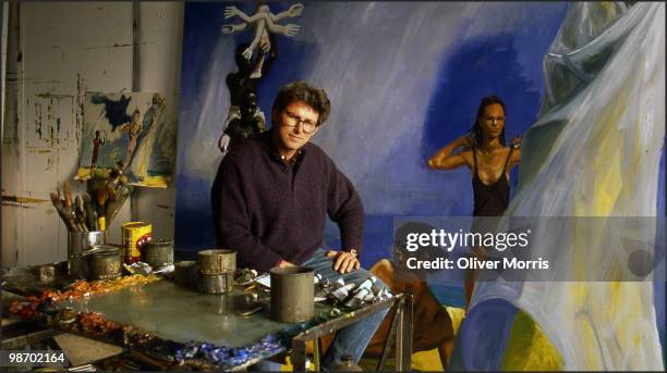 Portrait of American artist Eric Fischl as he poses in front of his painting 'A Brief History of North Africa' in his studio on Canal Street, New...