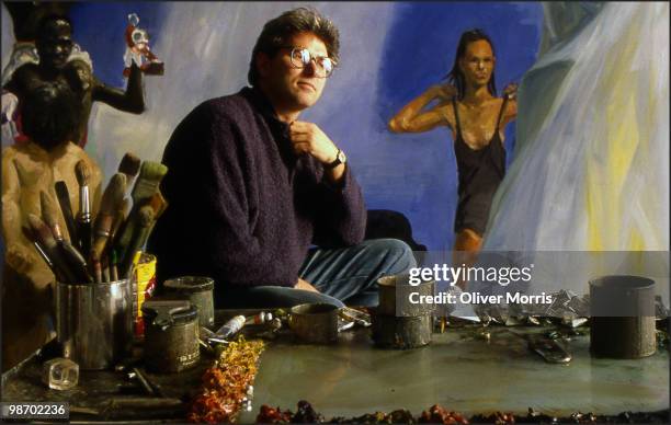 Portrait of American artist Eric Fischl as he poses in front of his painting 'A Brief History of North Africa' in his studio on Canal Street, New...