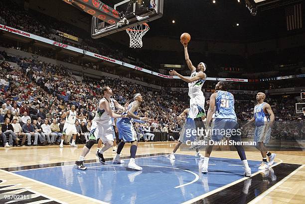 Corey Brewer of the Minnesota Timberwolves puts a shot up against Nene of the Denver Nuggets during the game on March 10, 2010 at the Target Center...