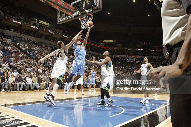 Nene of the Denver Nuggets goes up for the basket against Kevin Love the Minnesota Timberwolves during the game on March 10, 2010 at the Target...