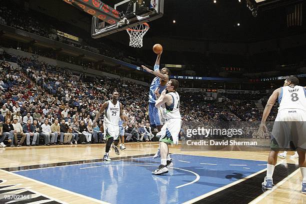 Nene of the Denver Nuggets goes up for the basket against Kevin Love of the Minnesota Timberwolves during the game on March 10, 2010 at the Target...